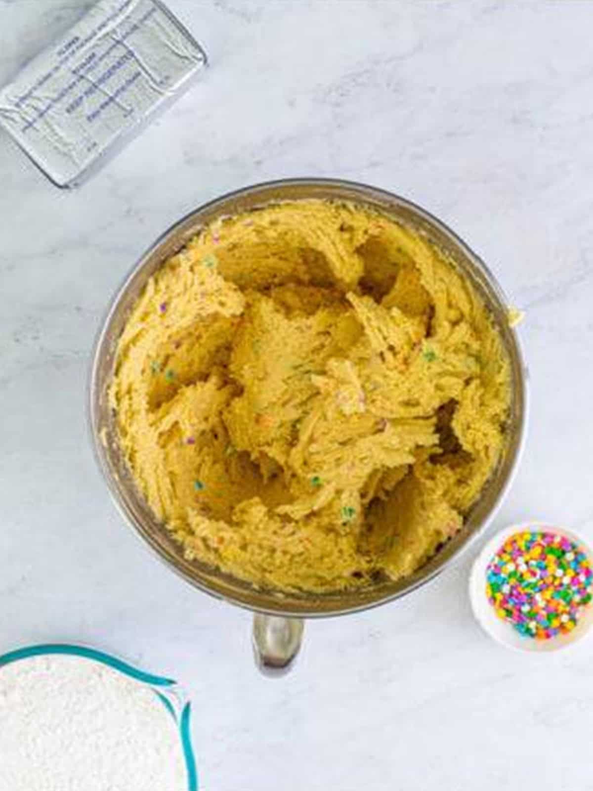 Pastel sprinkles folded into the confetti cake cookie dough until evenly distributed.