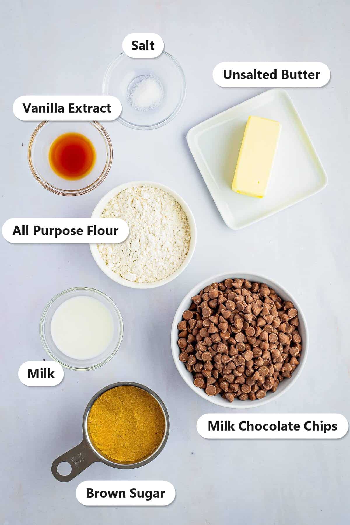The ingredients for cookie dough truffles labeled, flour, butter, brown sugar, vanilla extract, salt, milk, and milk chocolate chips.