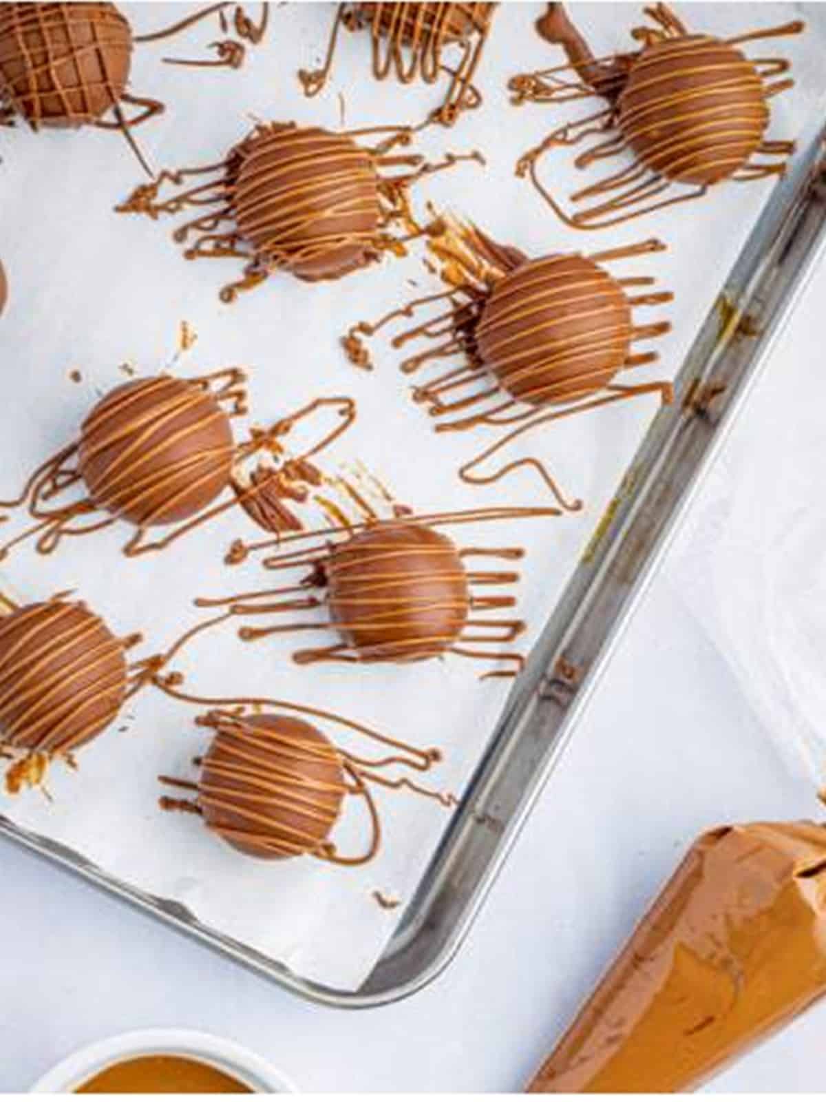 Melted chocolate drizzled over the coated cookie dough truffles.