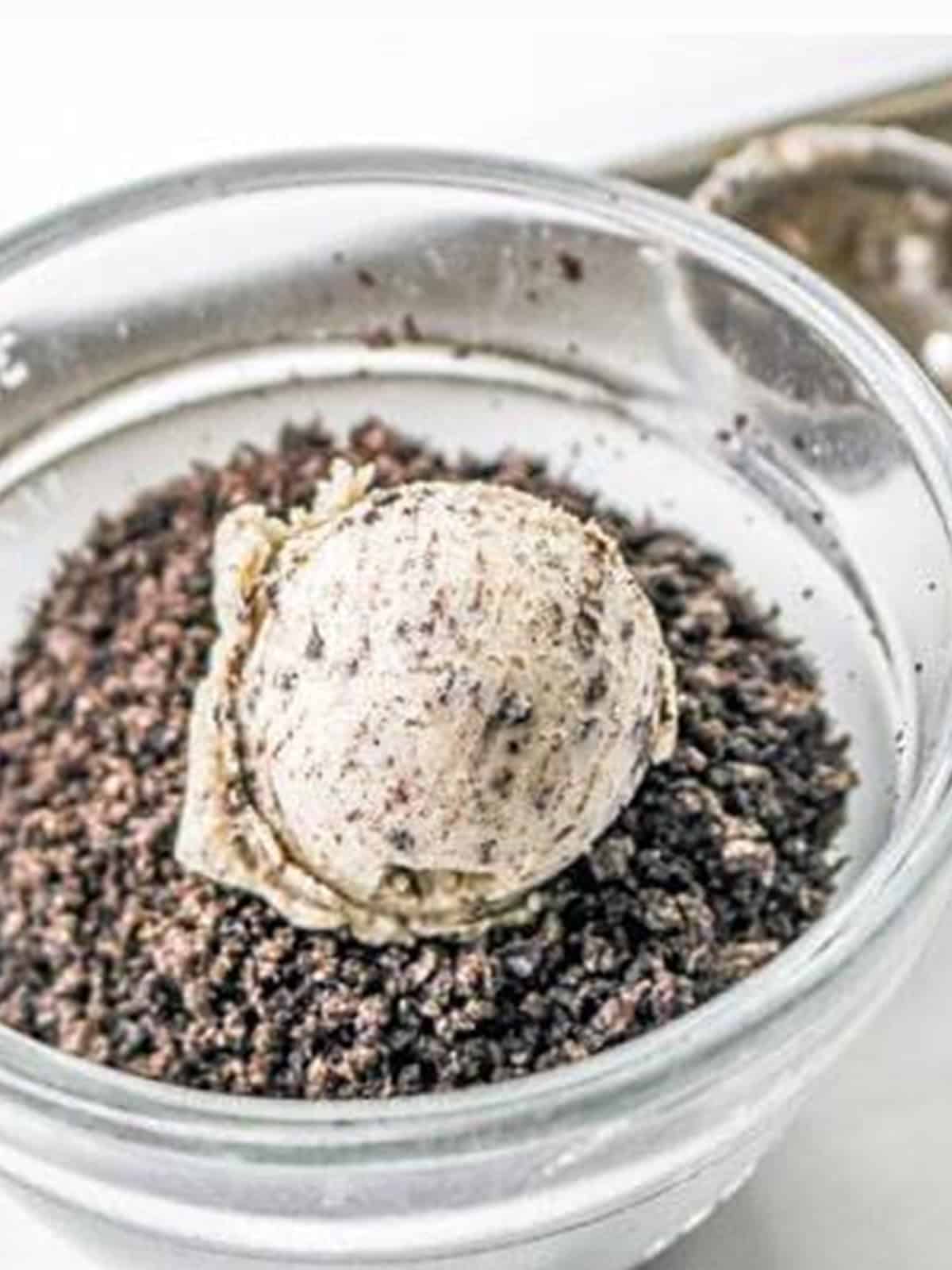 Cookie dough ball rolled in crushed Oreo crumbs before baking.