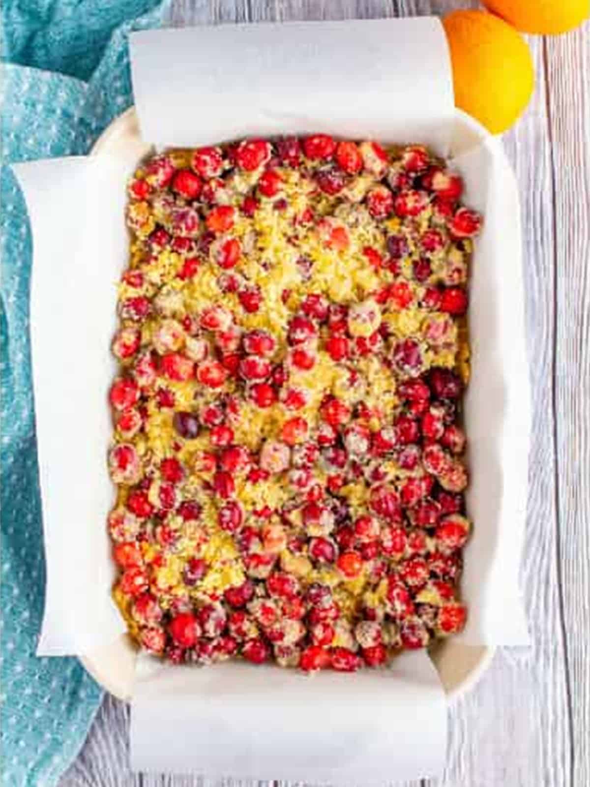 Cranberry filling poured over the pressed oat crust in the baking dish.