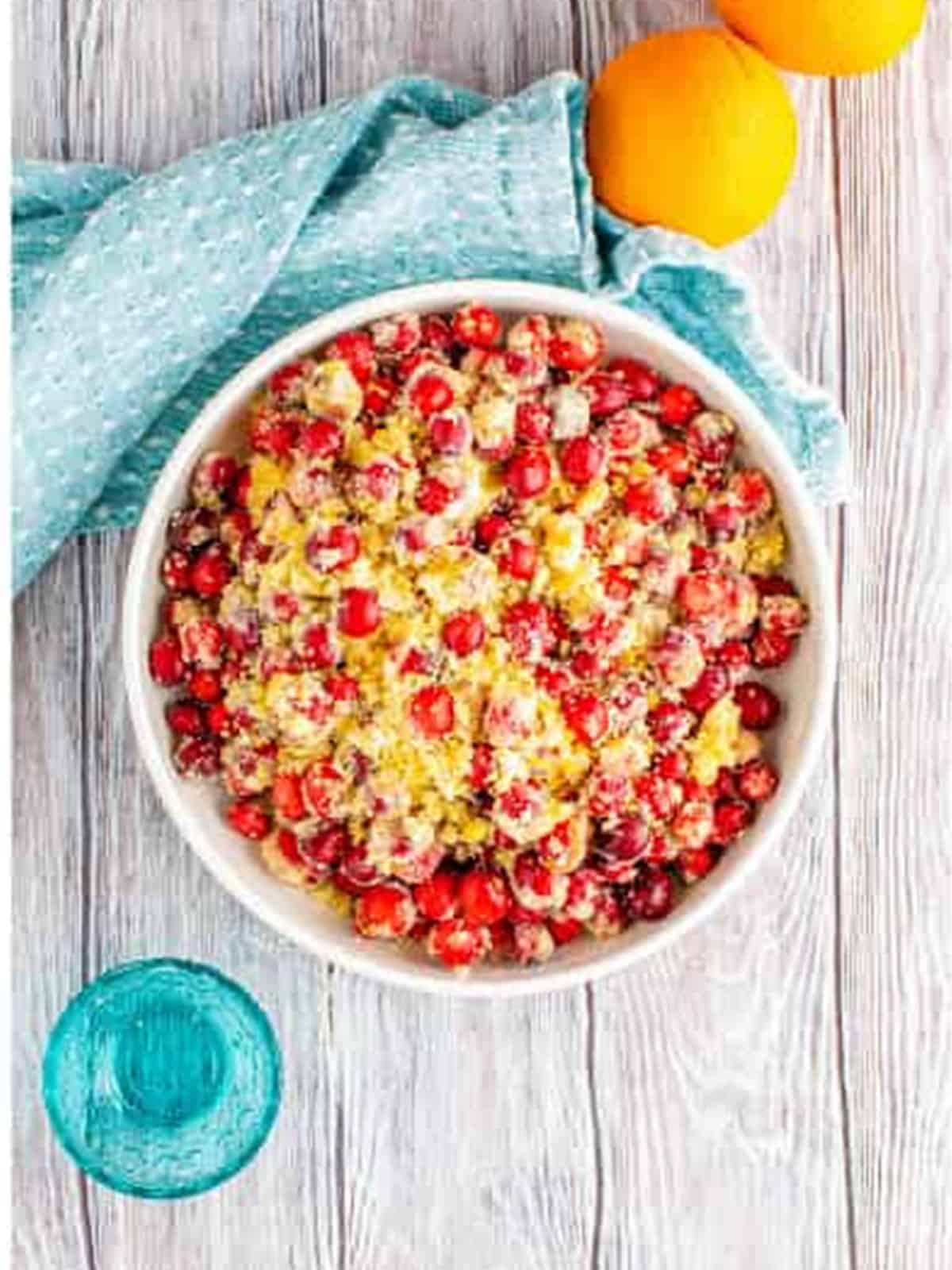 Fresh cranberry filling stirred together with sugar and orange zest in a mixing bowl.