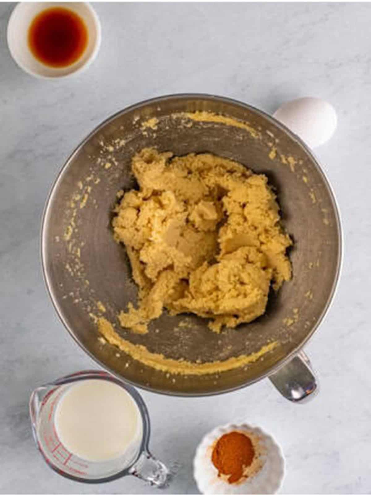 Butter creamed with granulated and brown sugar in a mixer bowl.