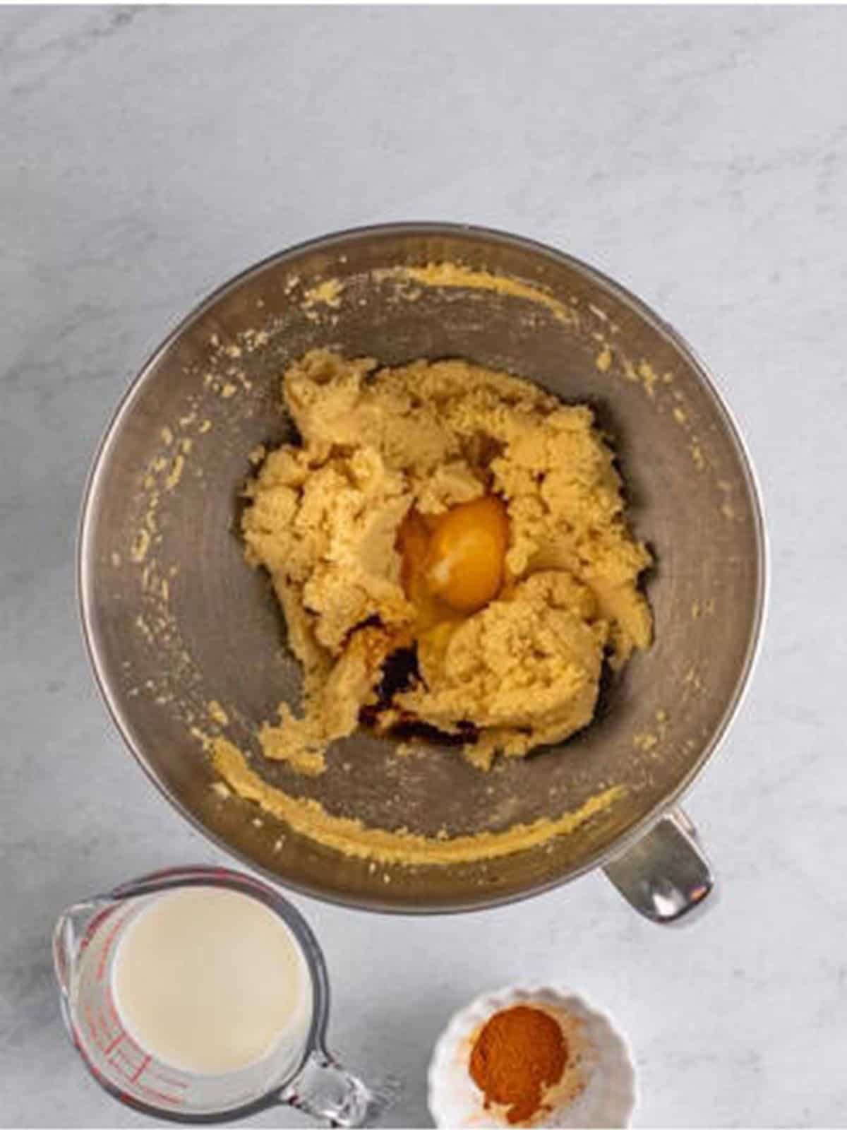 Egg and vanilla added to the creamed butter mixture.