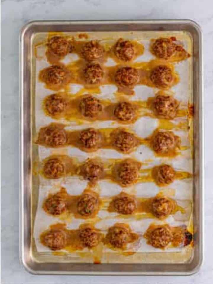 Baked Cranberry Meatballs on the sheet tray, golden brown and ready for the slow cooker.