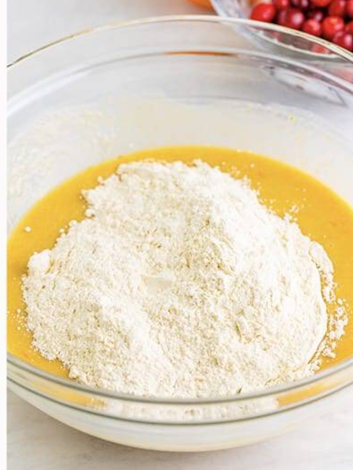 Flour mixture added to the wet ingredients for Cranberry Orange Muffins batter.