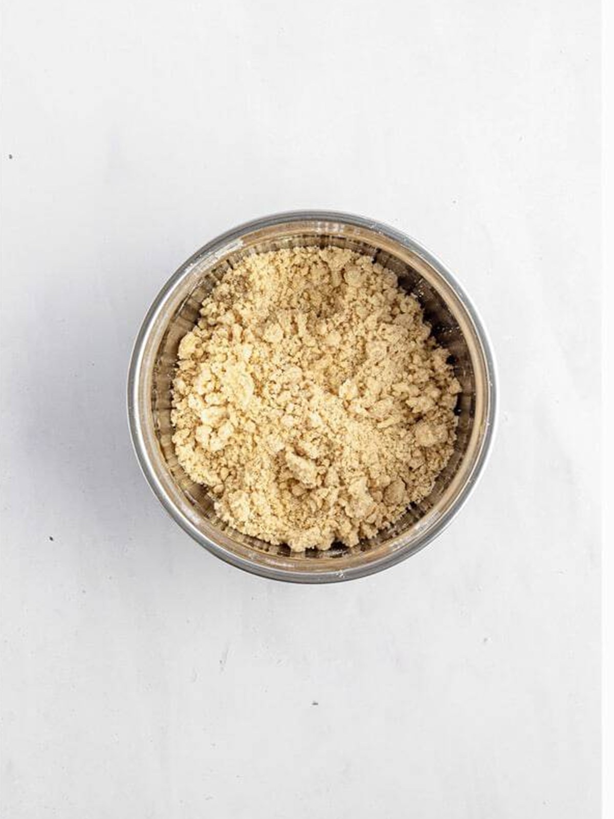 Buttery crumb topping mixed in a bowl for cream cheese crumb cake.