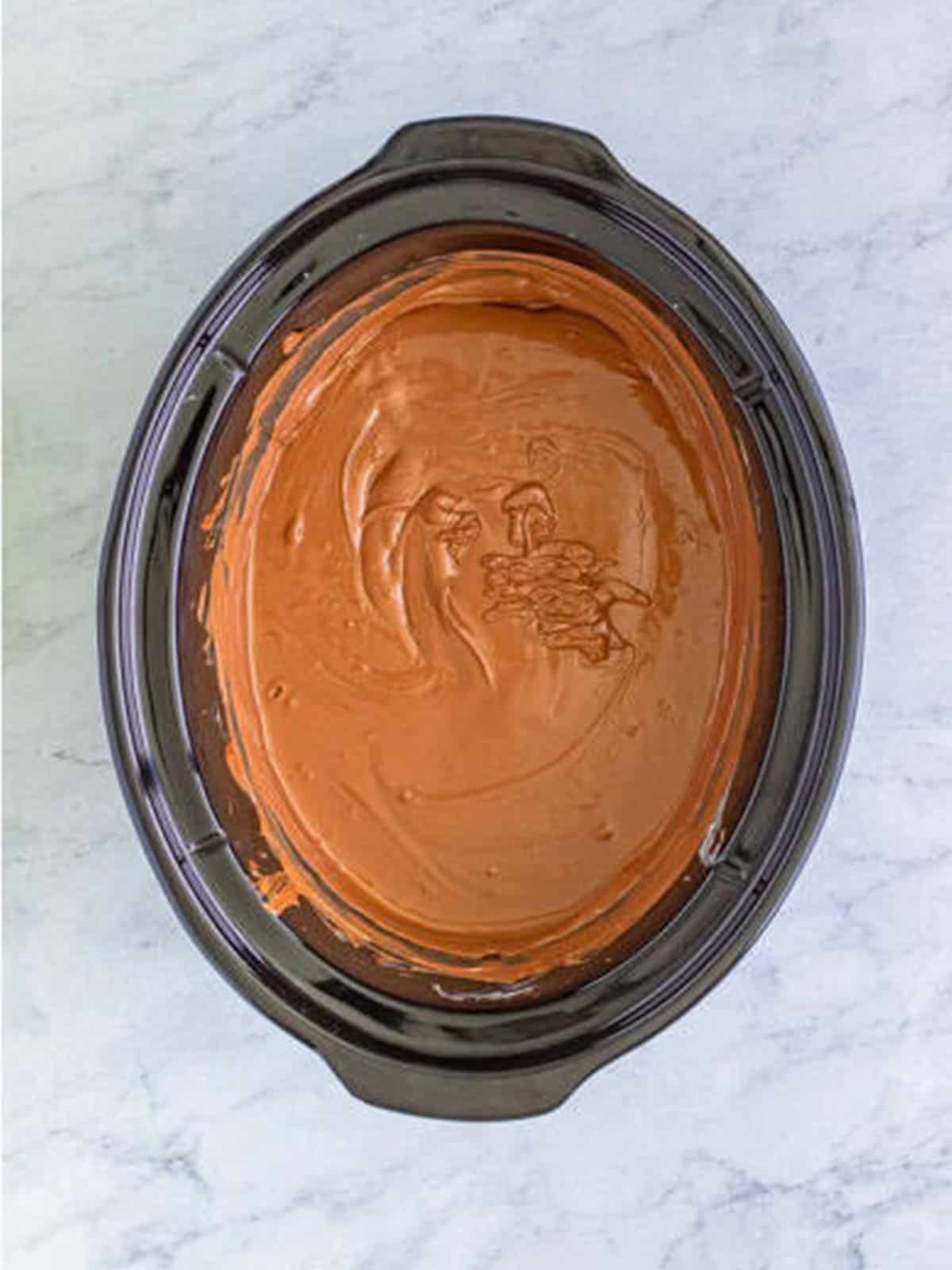 Chocolate fully melted and smooth in the slow cooker after stirring