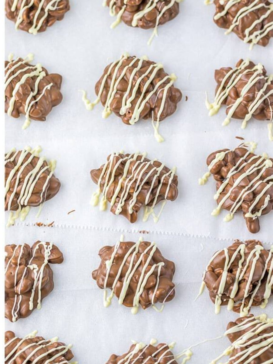 White chocolate drizzled over the cooled Crockpot Candy clusters.