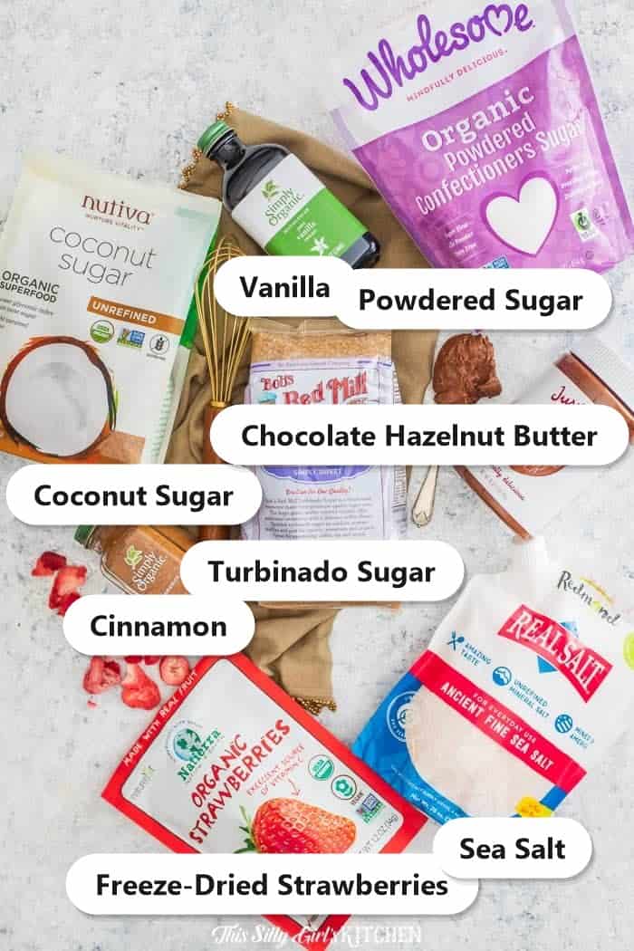 Labeled ingredients to make Cruffins: coconut sugar, vanilla, powdered sugar, turbinado sugar, chocolate hazelnut butter, cinnamon, freeze-dried strawberries, and sea salt.