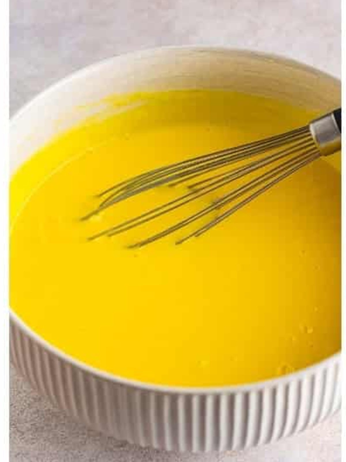 French vanilla pudding whisked with cold milk in a bowl for dirt cake.