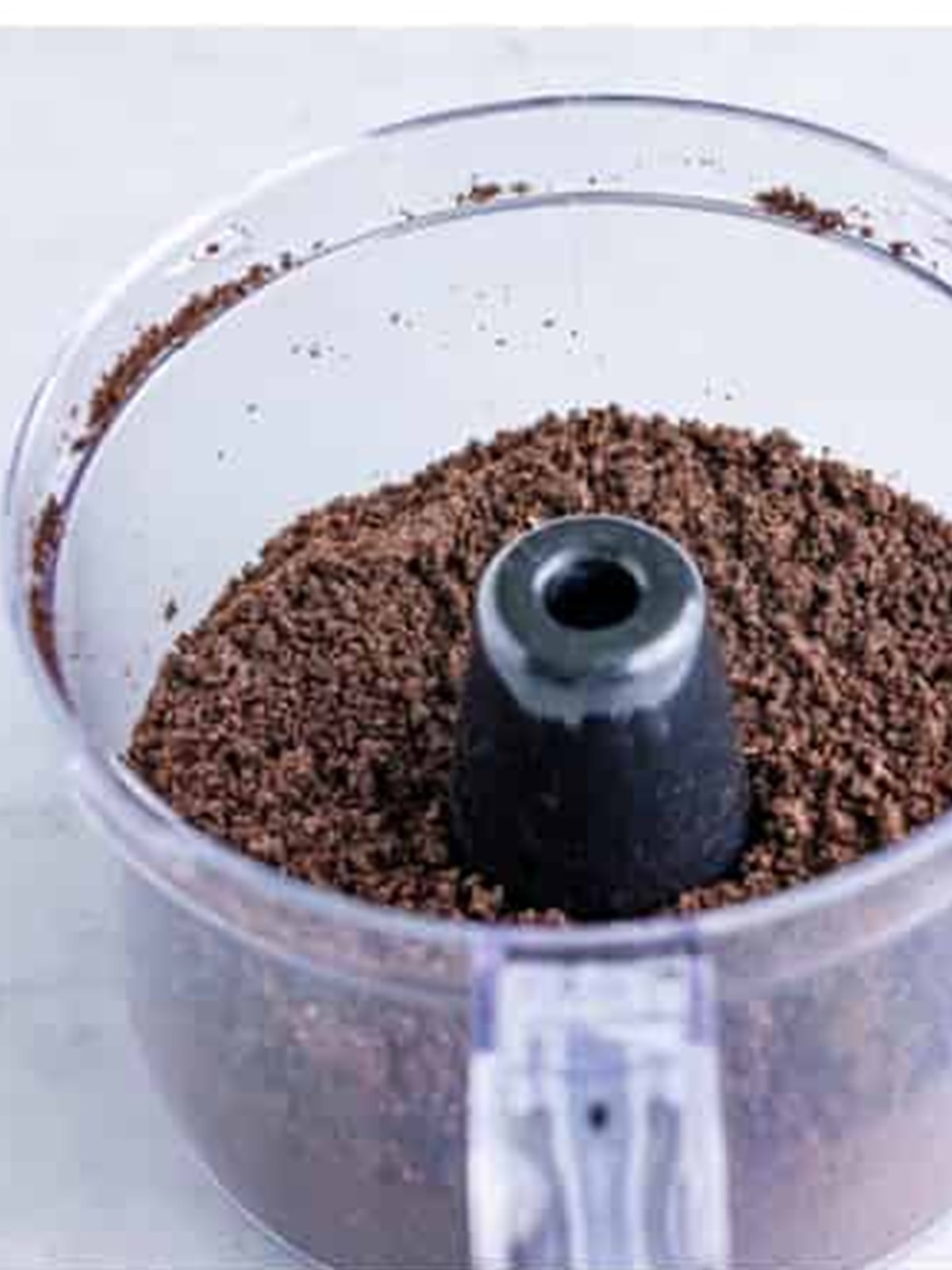 Crushing Oreos into fine crumbs in a food processor for dirt cups.