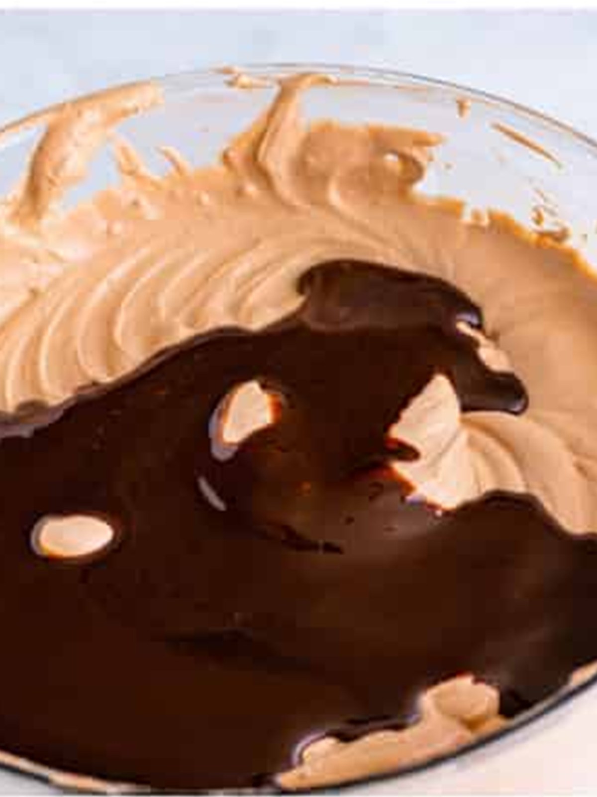 Folding whipped topping into the chocolate pudding until smooth.