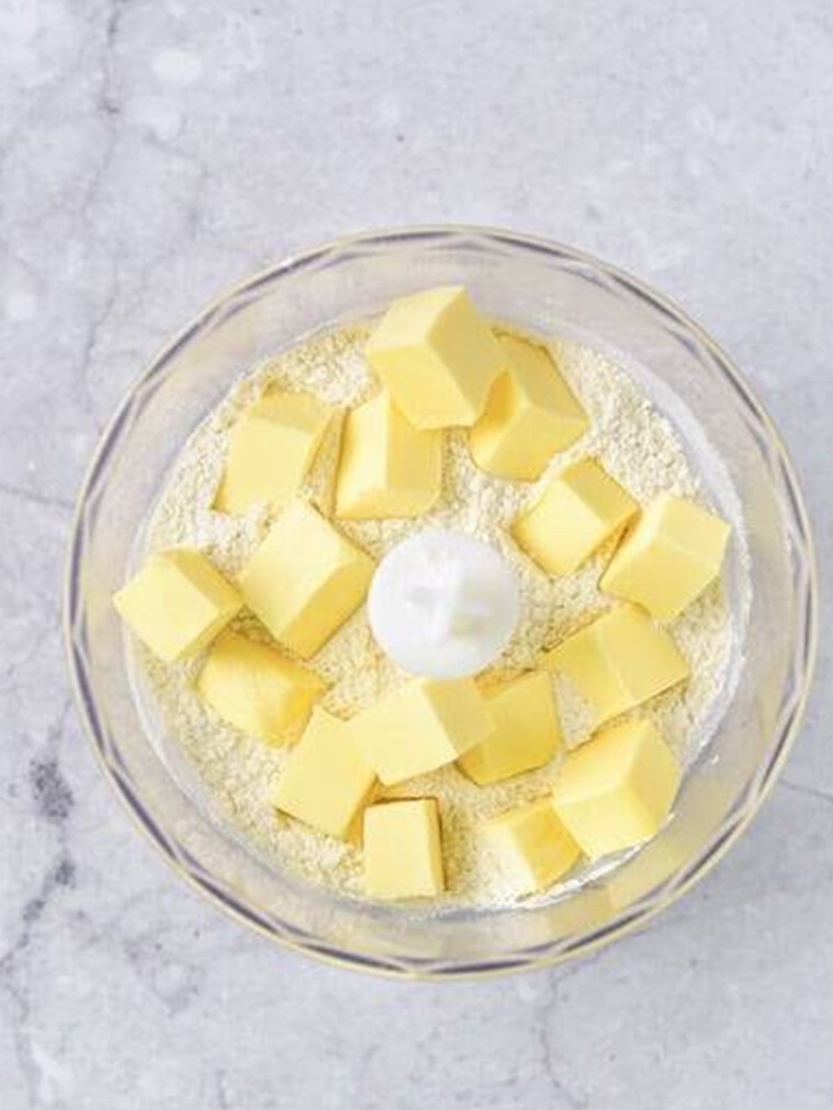 Cold cubed butter added to the dry ingredients for Easter bunny cookie dough.