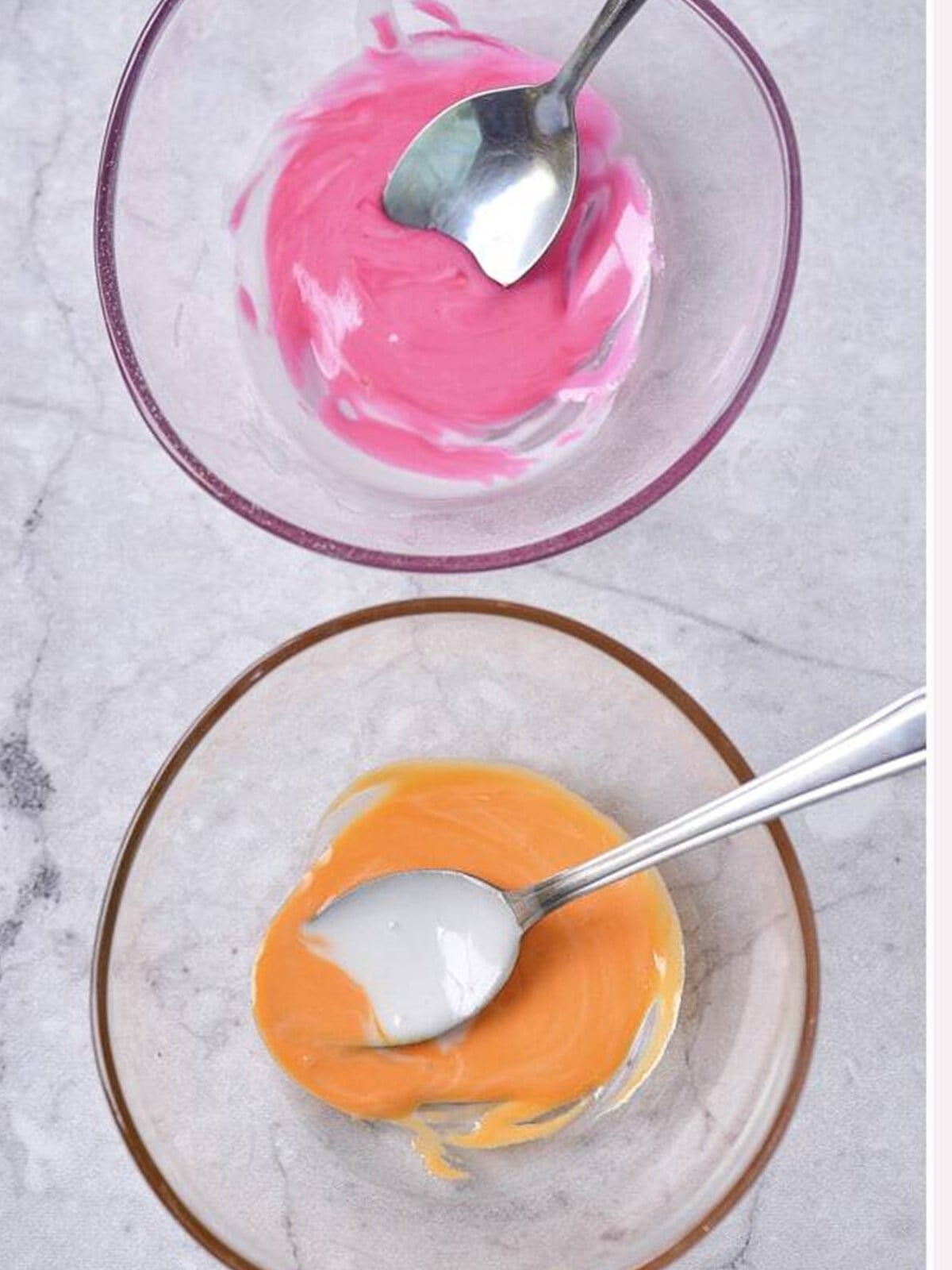 White glaze tinted pink and orange in small bowls for decorating.