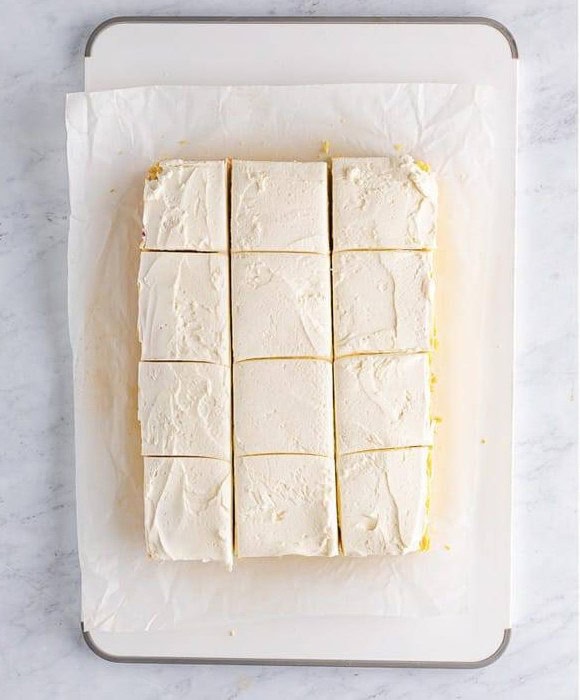 Frosted Easter Cookie Bars cut into squares before adding coconut.