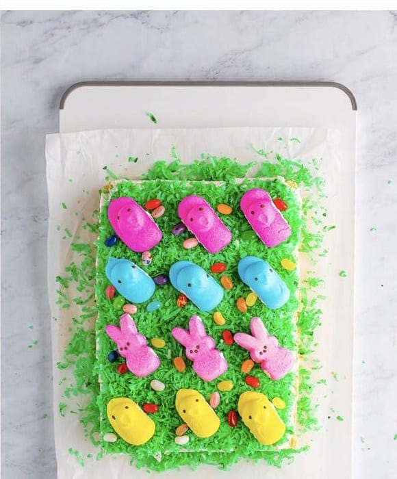 Easter Peeps and jelly beans added on top of the green coconut Easter Cookie Bars.