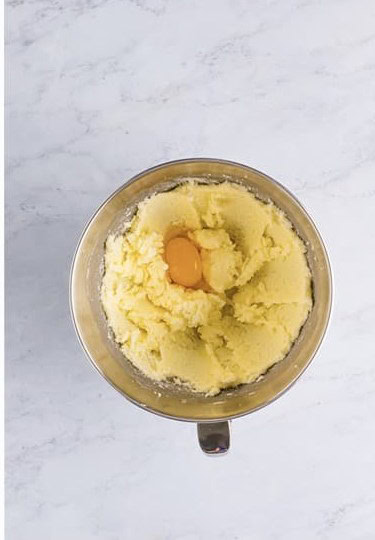 Eggs added one at a time to the creamed butter and sugar mixture.