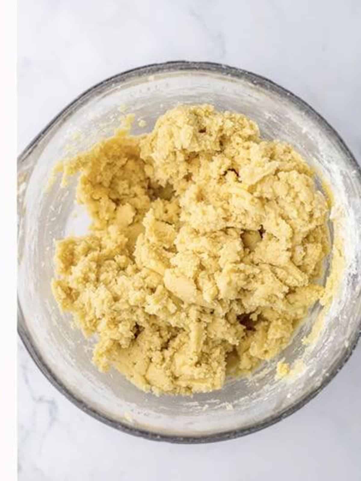 Finished Easter sugar cookie dough mixed in a glass bowl ready to divide and color.