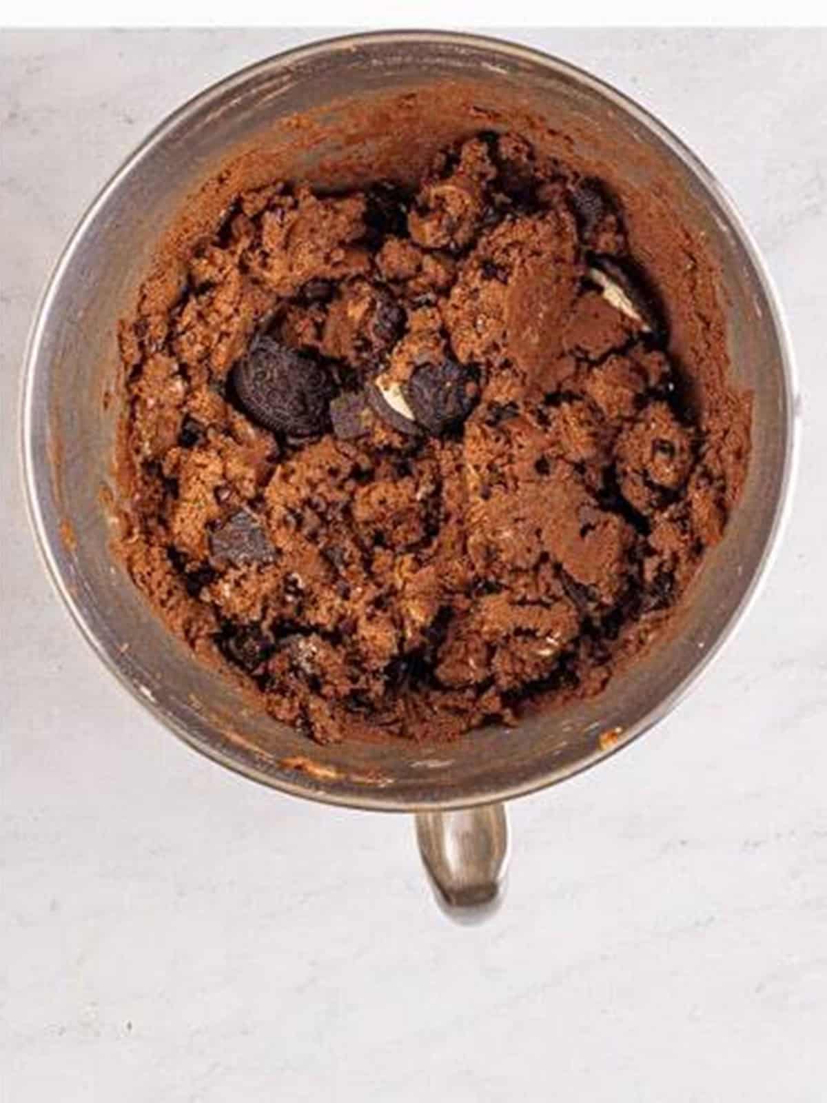 Finished edible chocolate cookie dough loaded with chocolate chips and Oreo chunks.