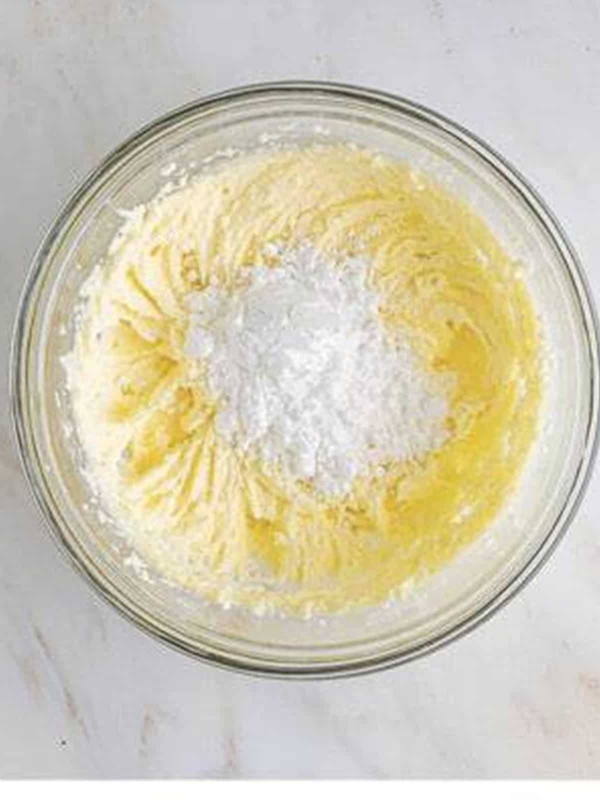 Butter and sugar creamed together in a glass bowl for cookie dough.