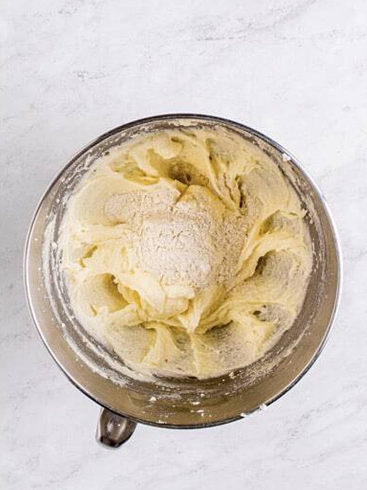 Heat treated flour added in batches to the edible sugar cookie dough mixture.