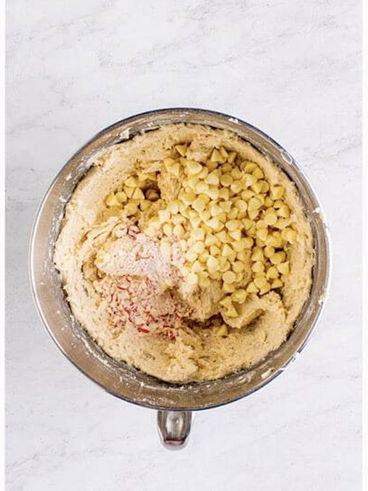 White chocolate chips and crushed peppermints folded into edible sugar cookie dough.