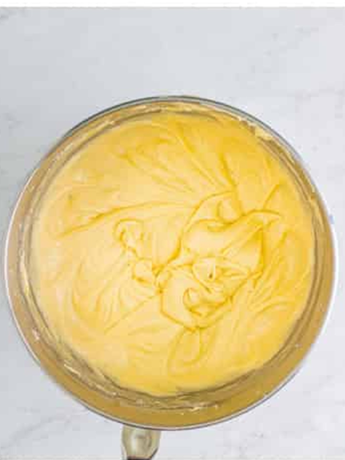 Finished eggnog cake batter mixed smooth in the stand mixer bowl.
