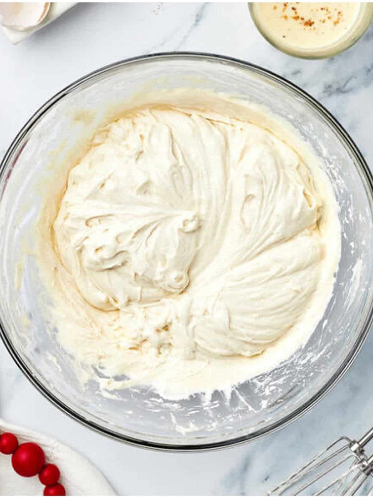 Fluffy eggnog cupcake batter beaten until it resembles marshmallow fluff.