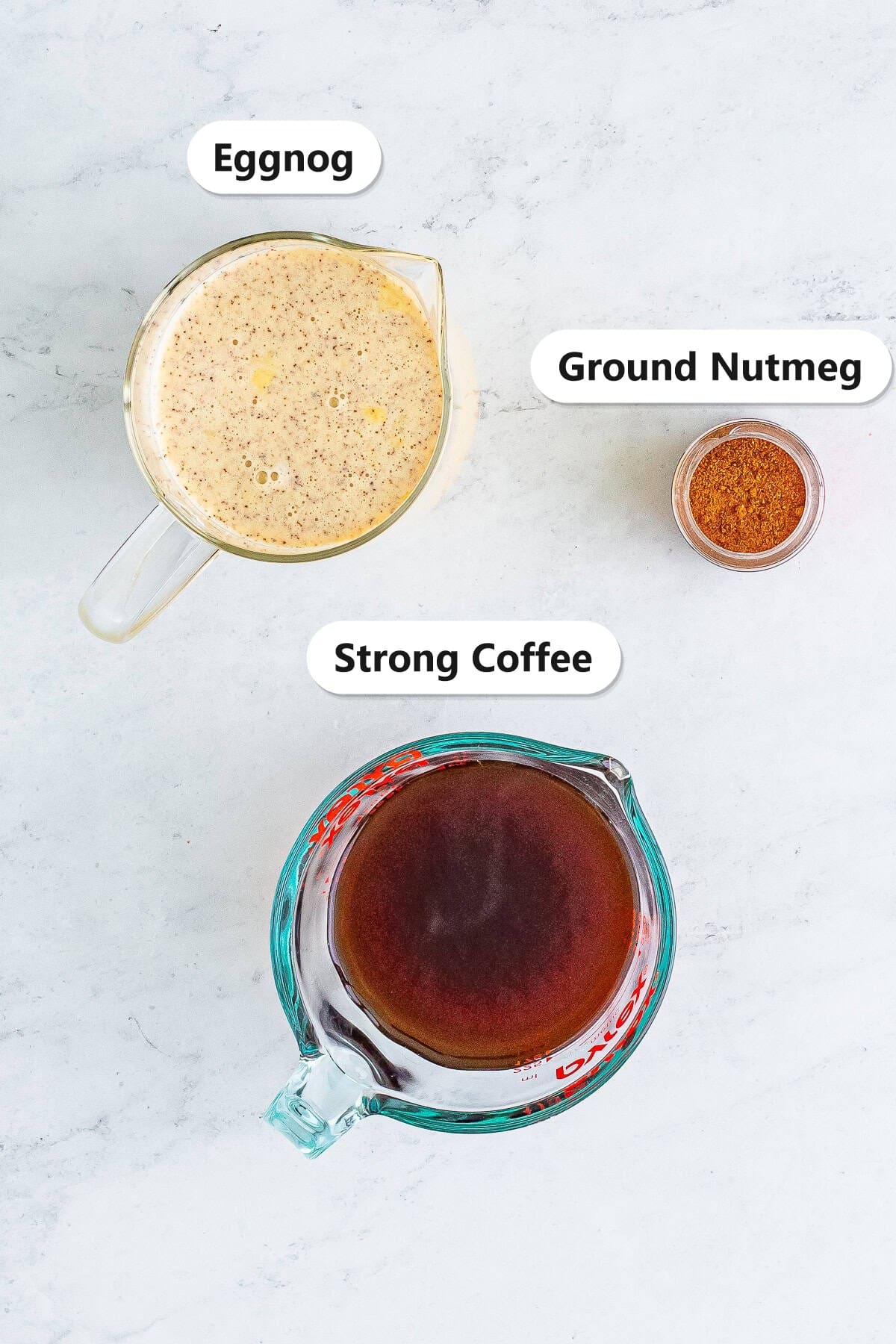 Labeled ingredients for an Eggnog Latte including eggnog, strong coffee, and ground nutmeg.