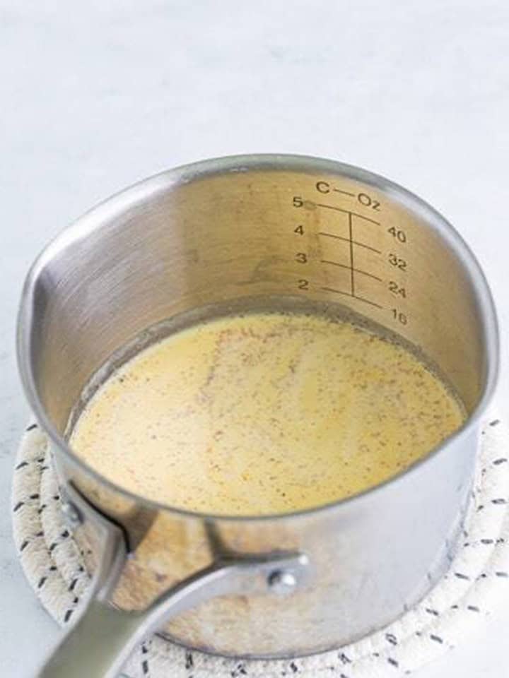 Warming eggnog in a small saucepan for an Eggnog Latte.