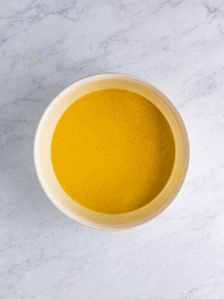 The eggnog pudding mixture whisked for two minutes until it starts to thicken.