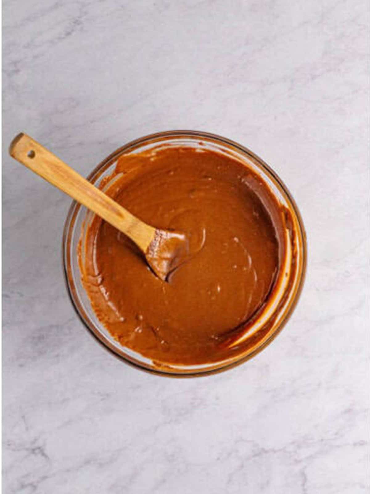 The fudge mixture stirred until completely smooth and glossy in the bowl.