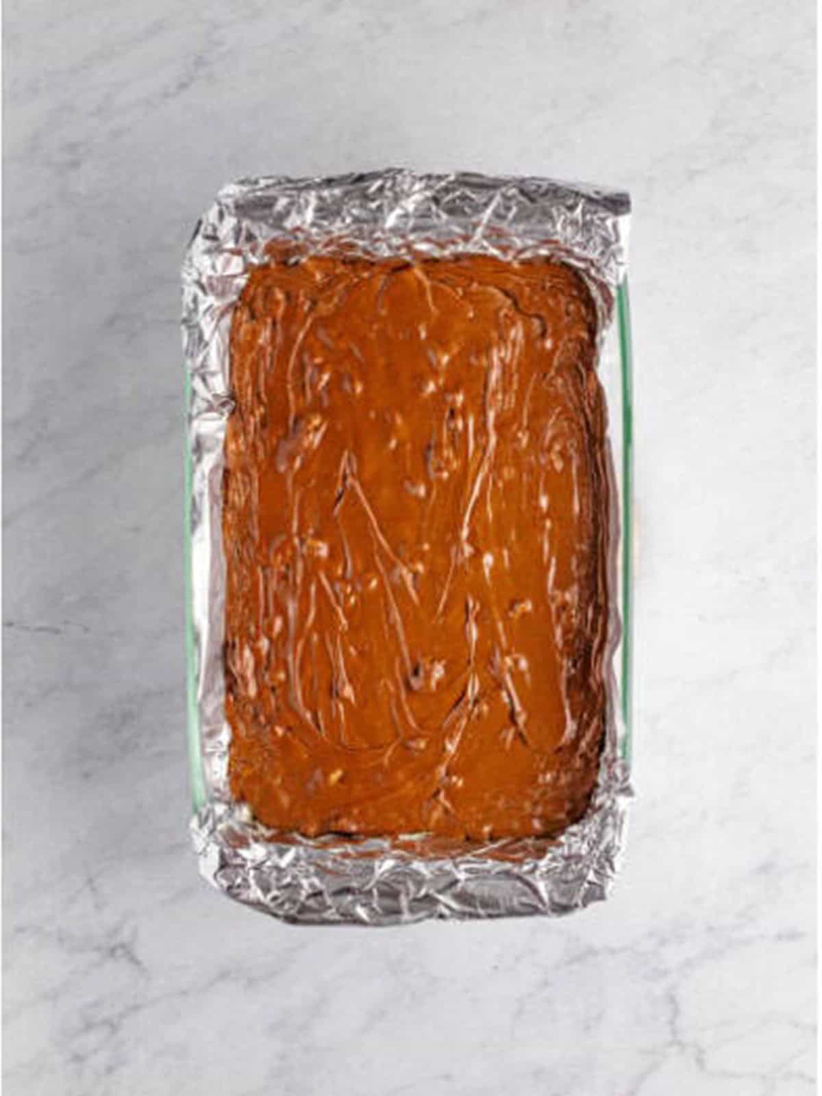 The walnut fudge spread evenly into a foil lined 9x13 baking dish to set.