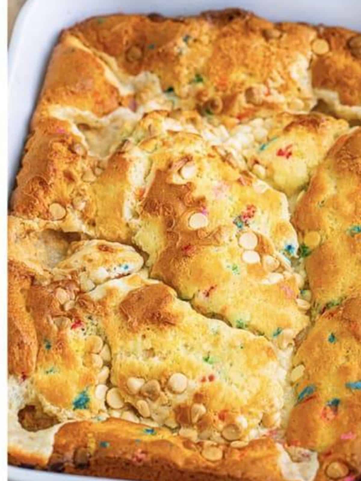 Baked funfetti earthquake cake with gooey cream cheese swirls in the pan.