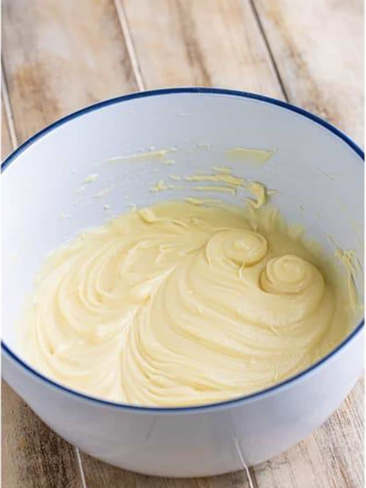 Cream cheese, butter, and powdered sugar beaten smooth in a bowl.
