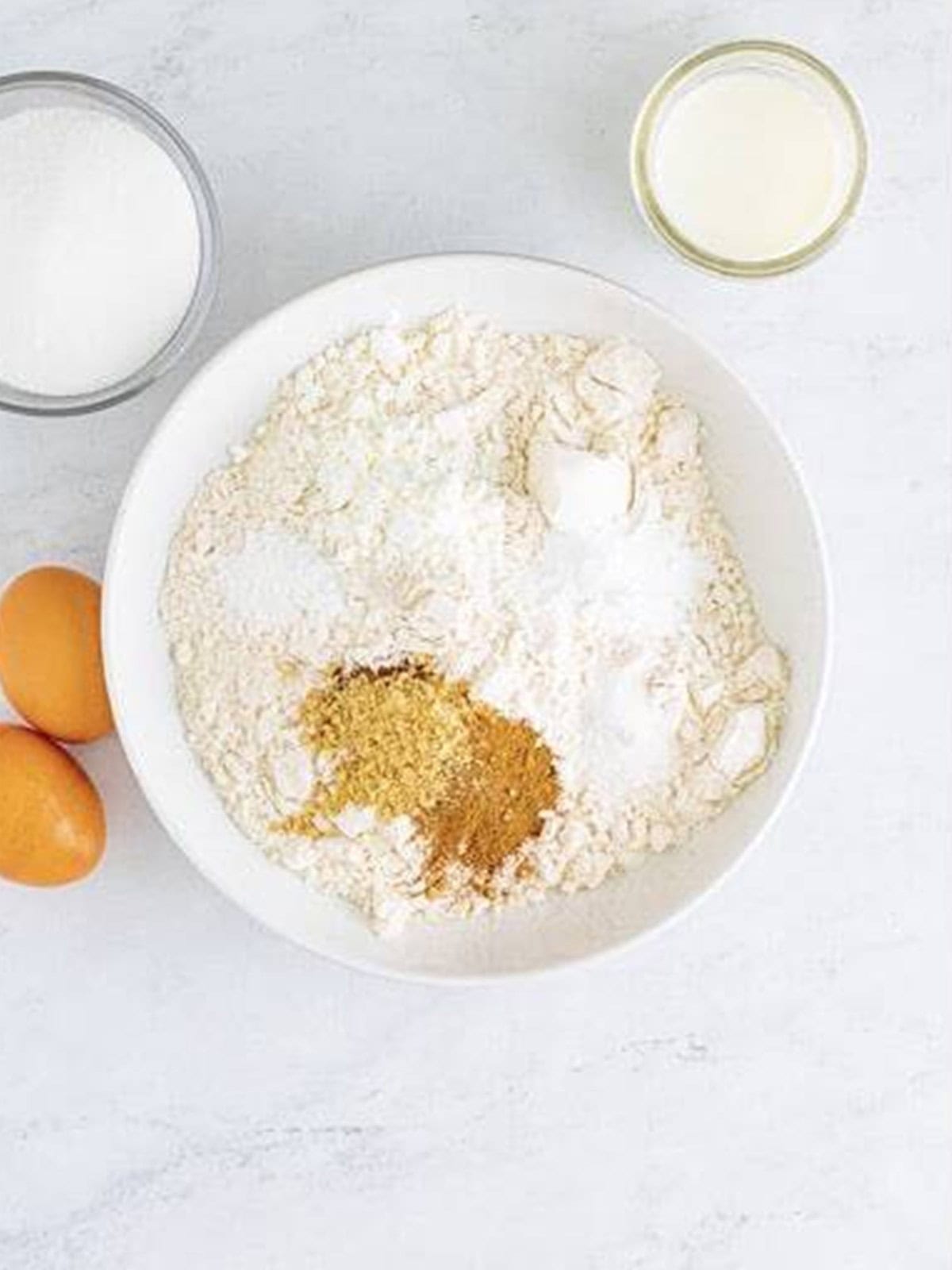 Flour, cornstarch, ginger, cinnamon, and spices stirred together for gingerbread bars.
