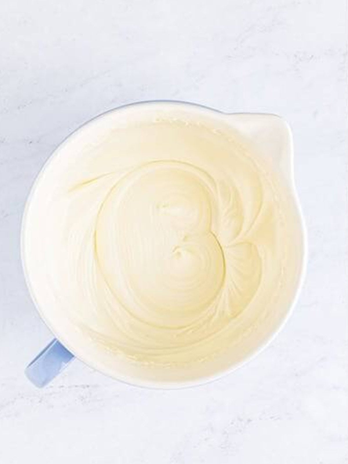 Fluffy cream cheese frosting whipped smooth for gingerbread bars.