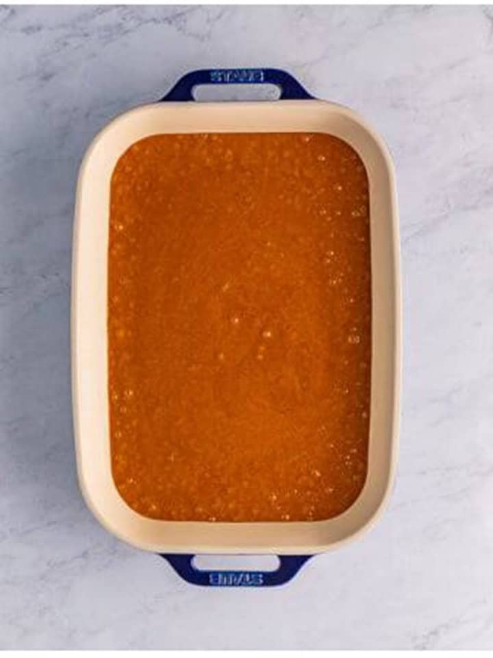 Gingerbread Cake batter poured and smoothed into a 9x13 baking dish.