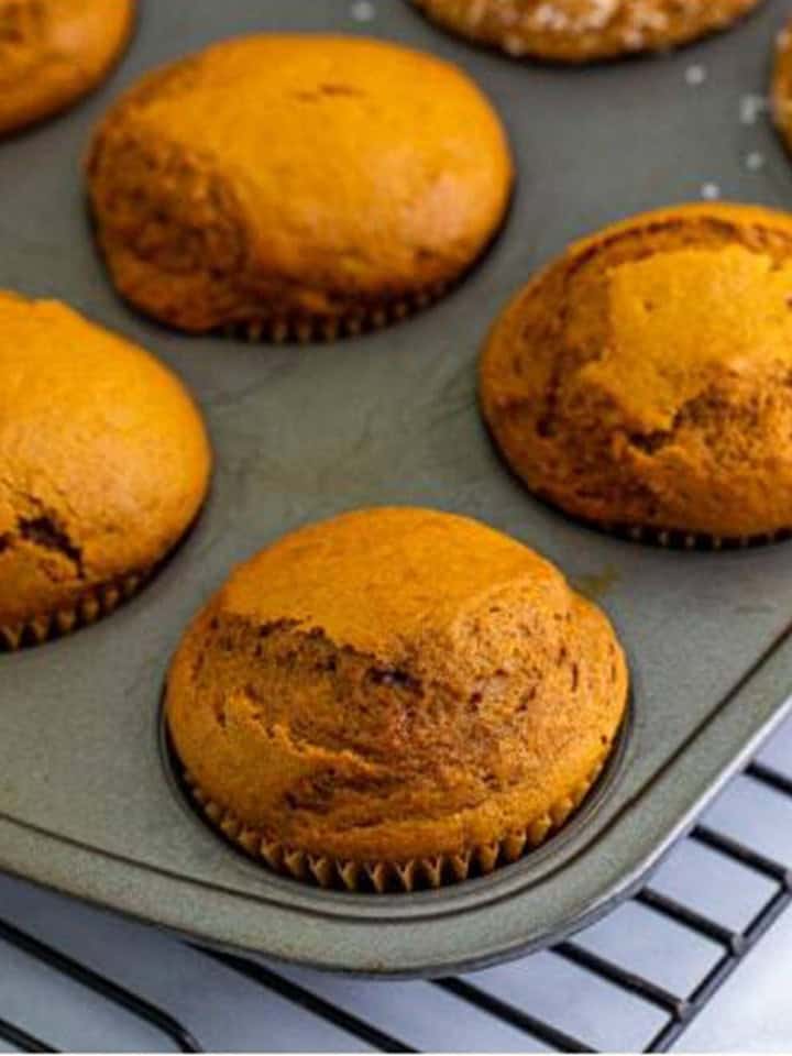 Tall domed gingerbread muffins fresh out of the oven.
