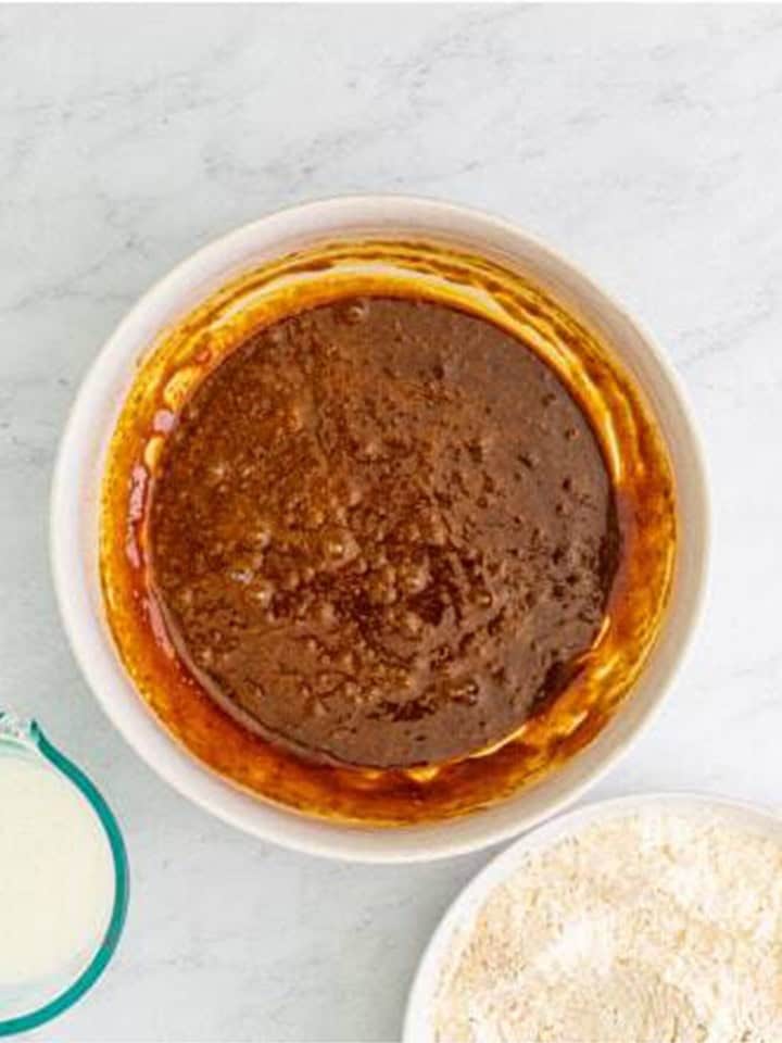 Brown sugar, molasses, melted butter, egg, and vanilla whisked together in a bowl.