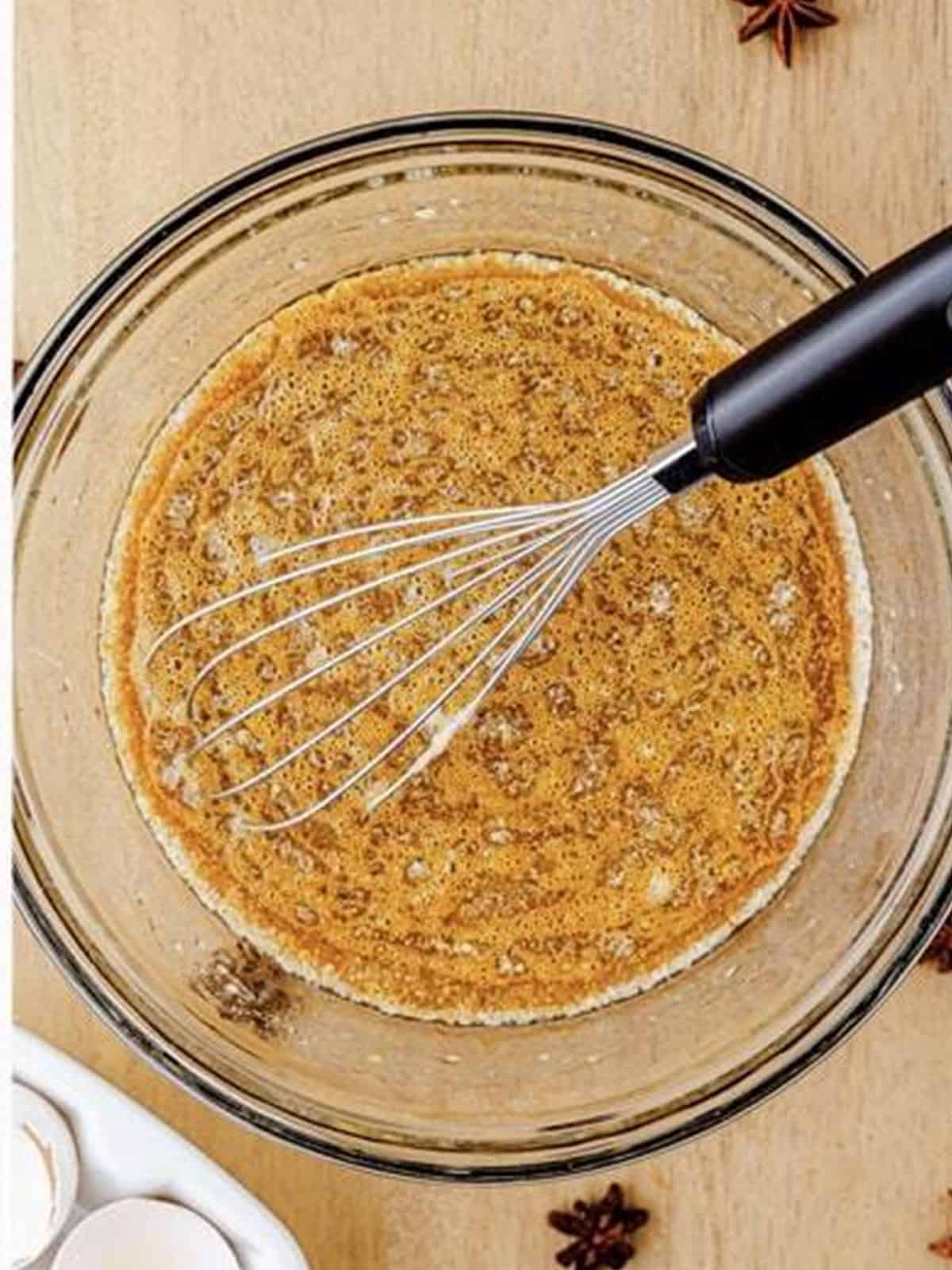Milk, oil, molasses, and vanilla whisked into the eggs for gingerbread waffle batter.