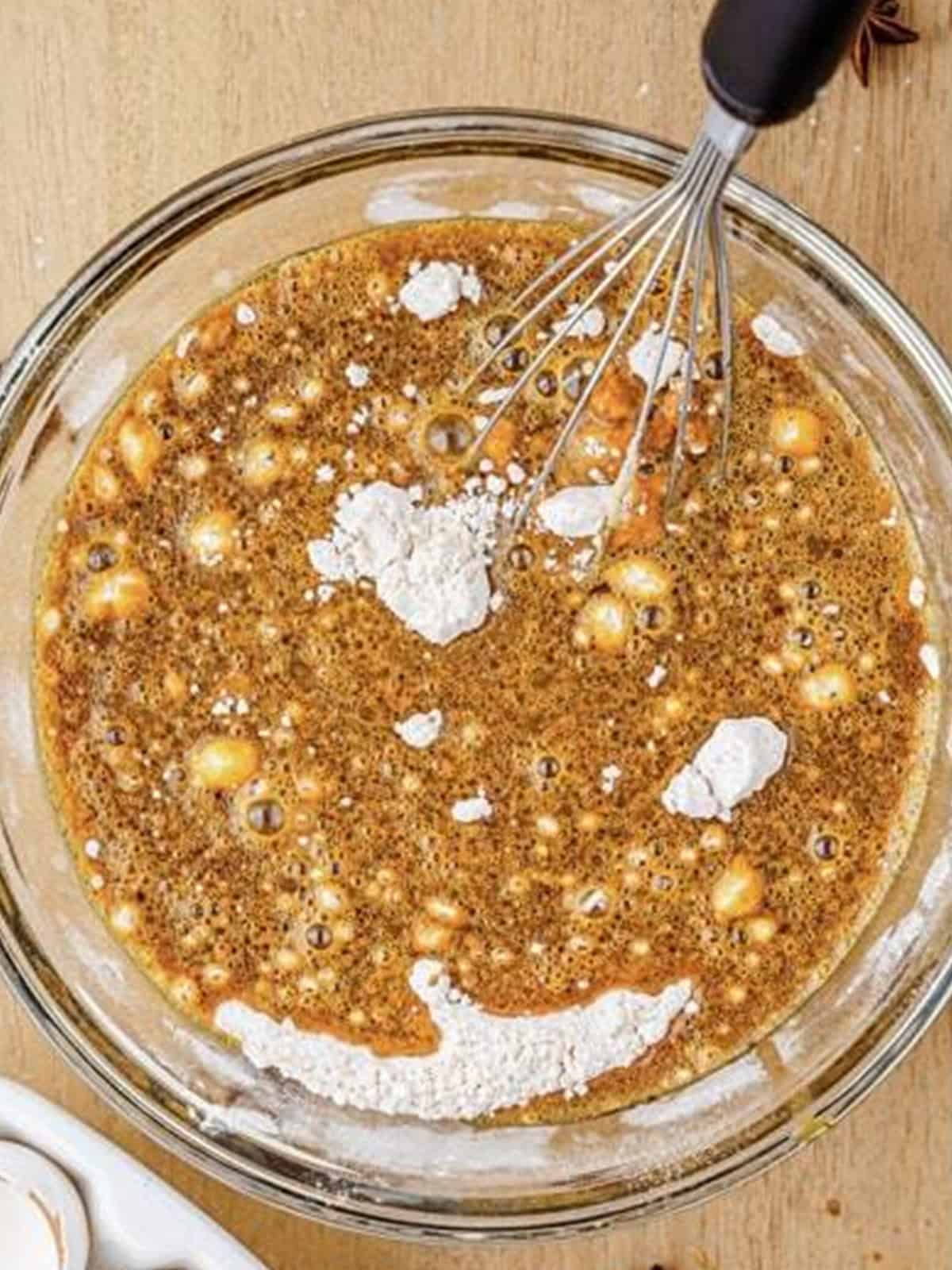 Dry ingredients being folded into the wet gingerbread waffle batter.