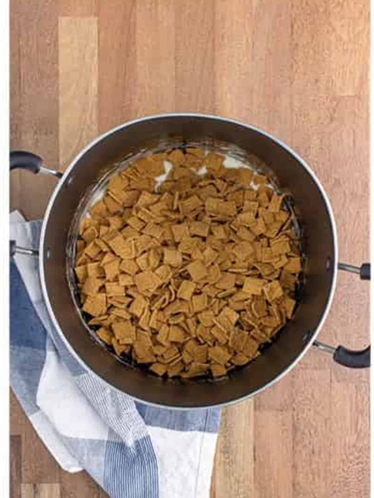 Golden Grahams cereal added to the melted marshmallow mixture for golden grahams smores bars.
