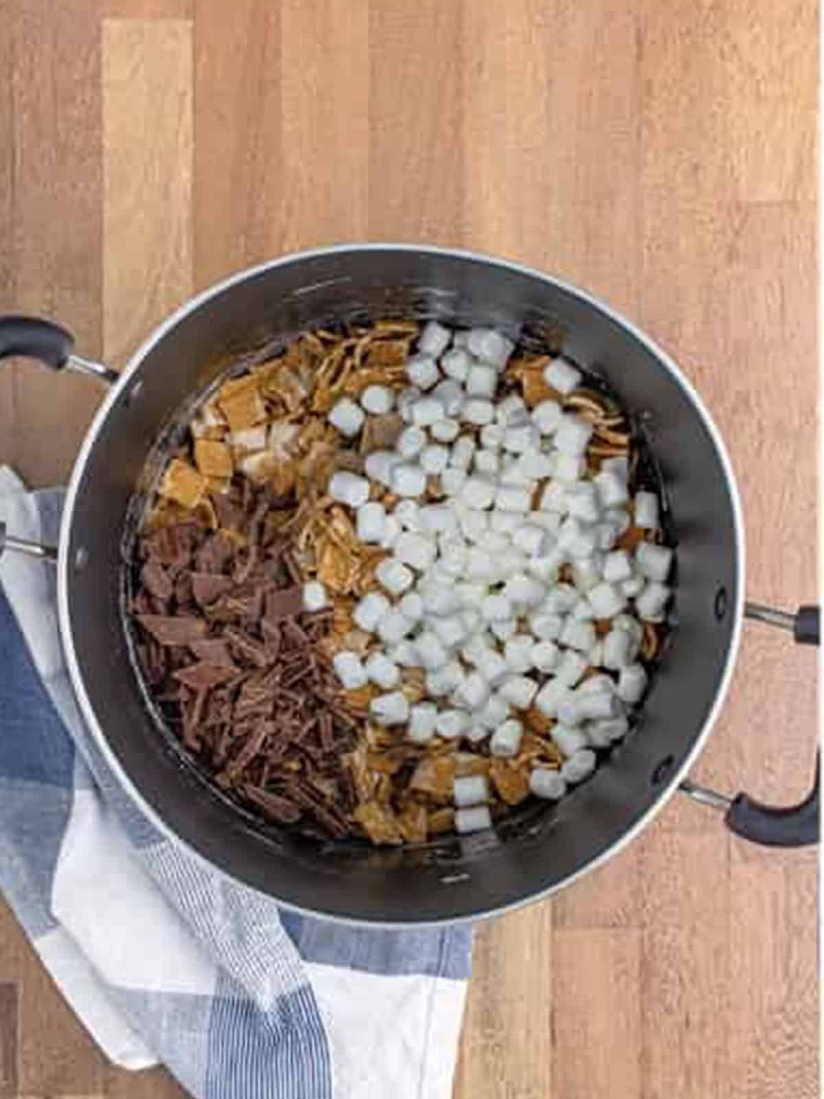 Extra mini marshmallows and chopped chocolate stirred into the cereal mixture for golden grahams smores bars.