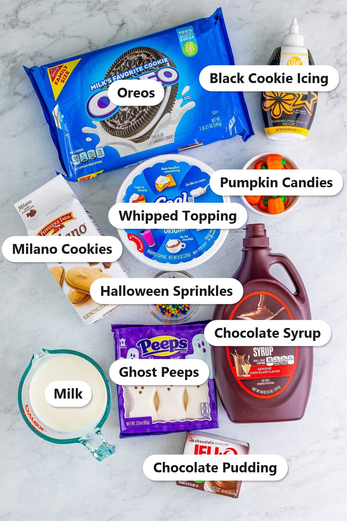 Oreos, chocolate pudding, whipped topping, chocolate syrup, Milano cookies, ghost Peeps, and Halloween candies for graveyard dirt cups.