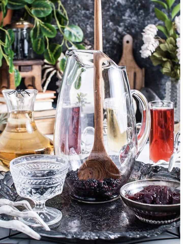 Chilled juices and pitcher arranged on a tray to start the Halloween Punch.