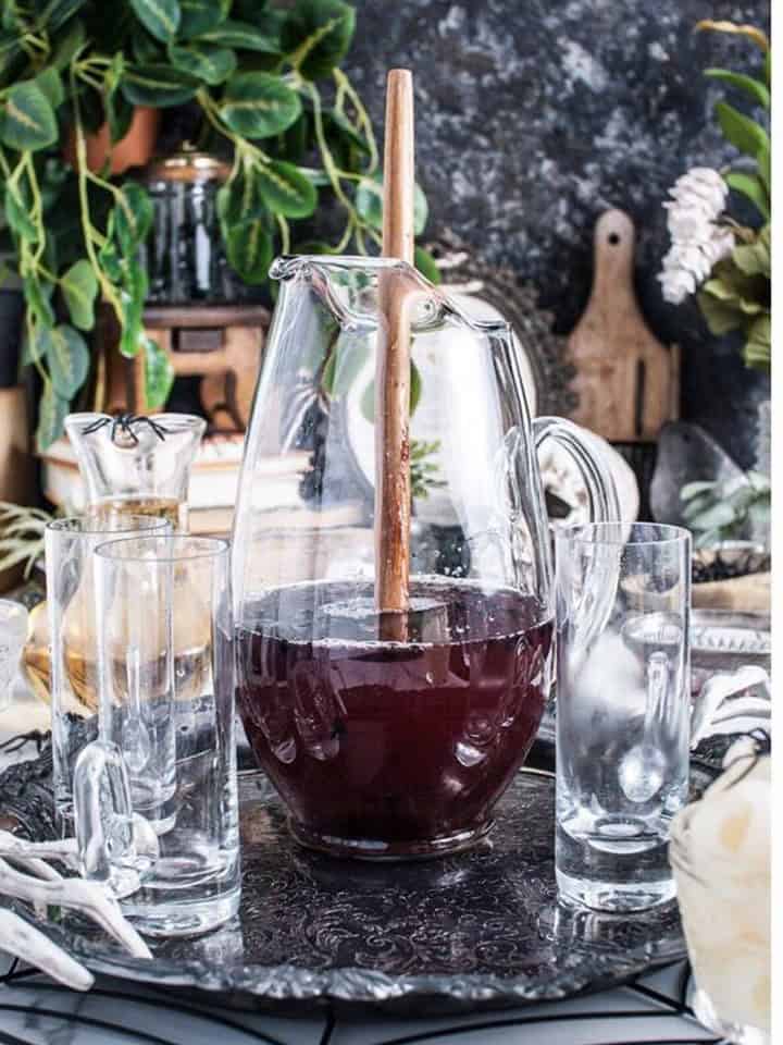 Stirring the Halloween Punch with a long wooden spoon.