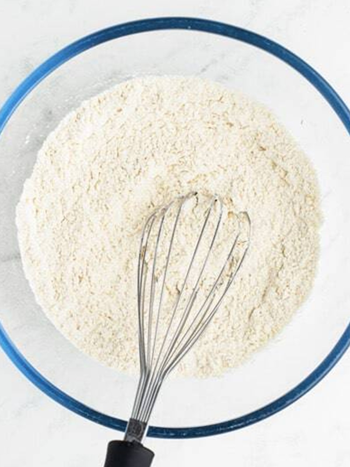 Whisking the flour, baking powder, cornstarch, and salt together in a glass bowl.