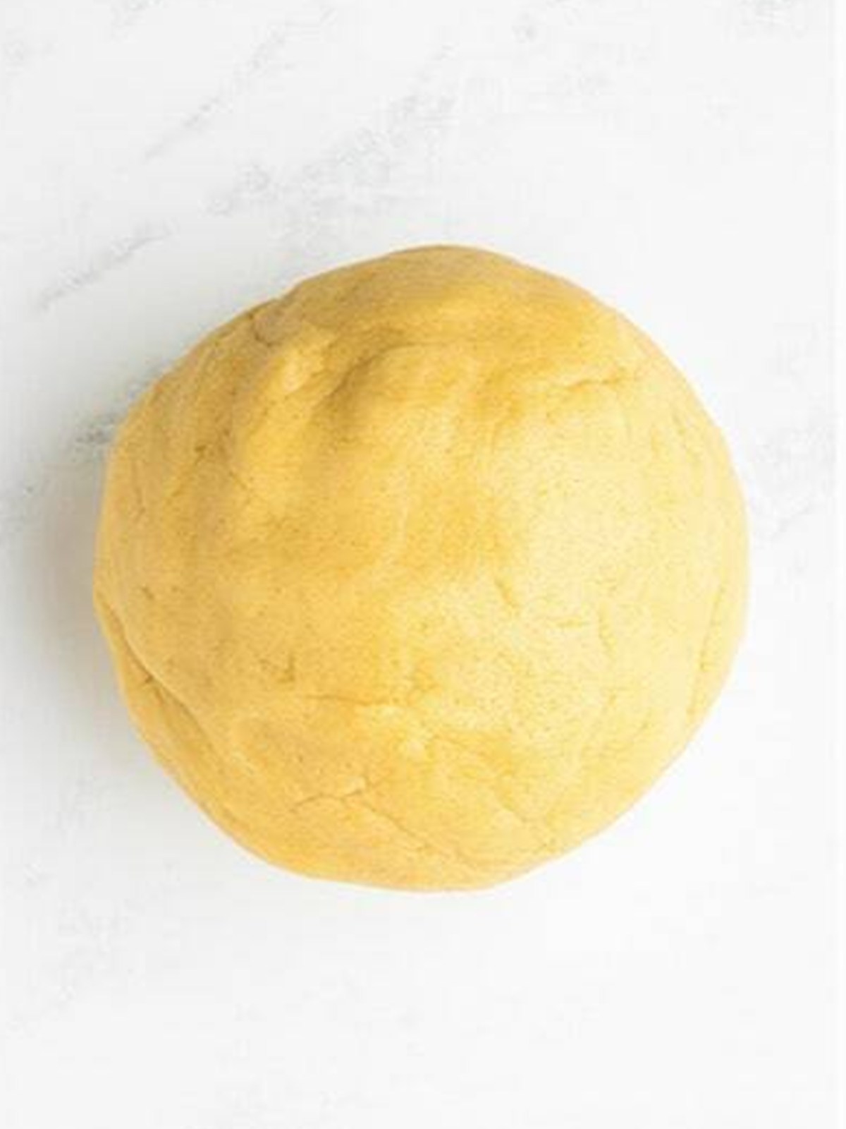 A smooth ball of chilled sugar cookie dough ready to roll out.
